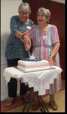 Gaby and Elsie cutting the cake